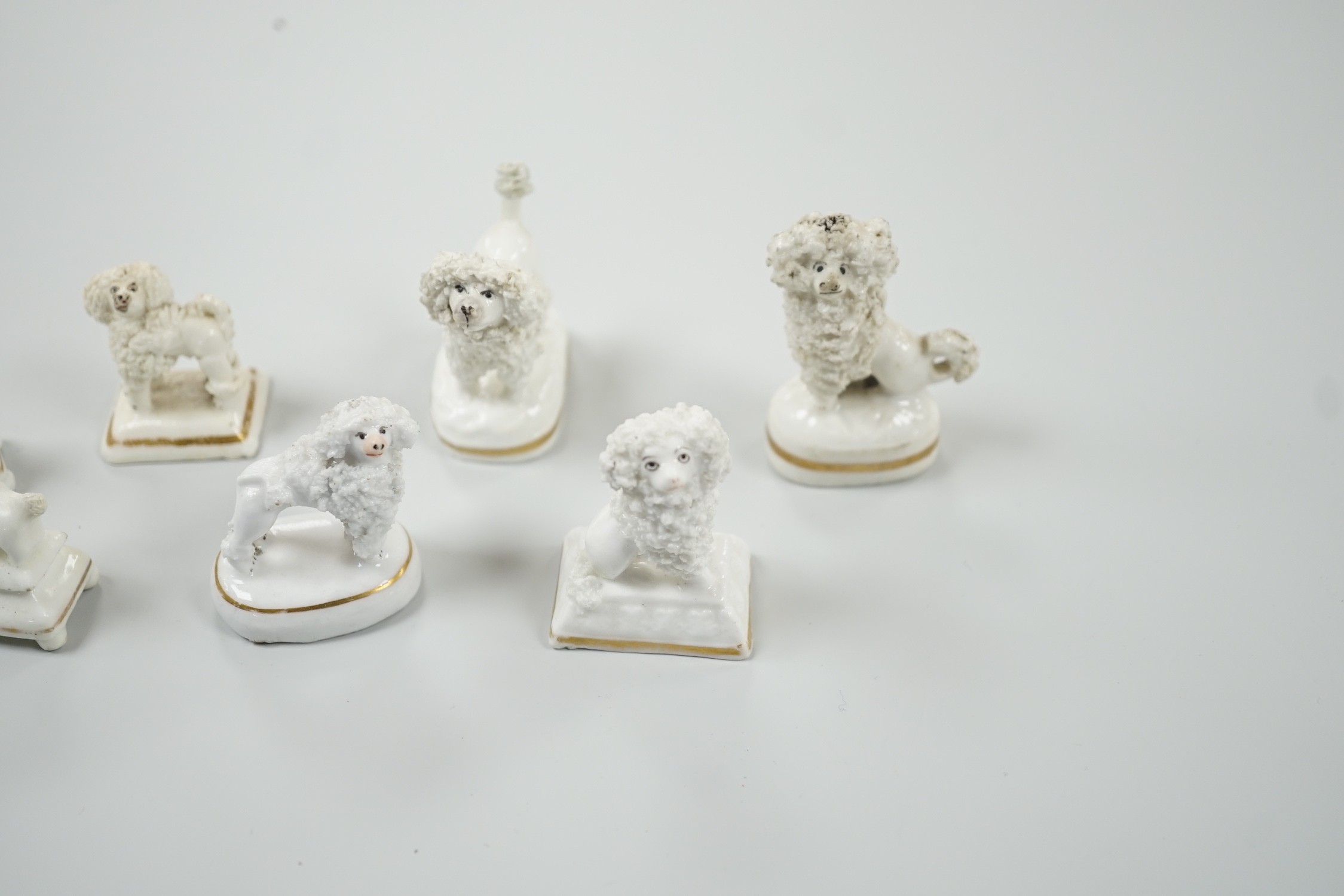 Four small Staffordshire porcelain models of poodles, together with five toy Staffordshire models of poodles, c.1830-50. Largest 5cm tall, Provenance- Dennis G Rice collection